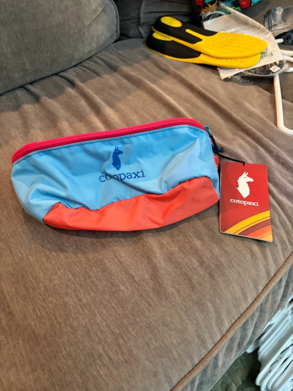 cotopaxi light blue and coral travel pouch with pink zipper